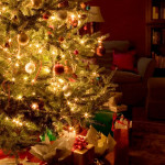 A lighted Christmas tree with presents underneath.